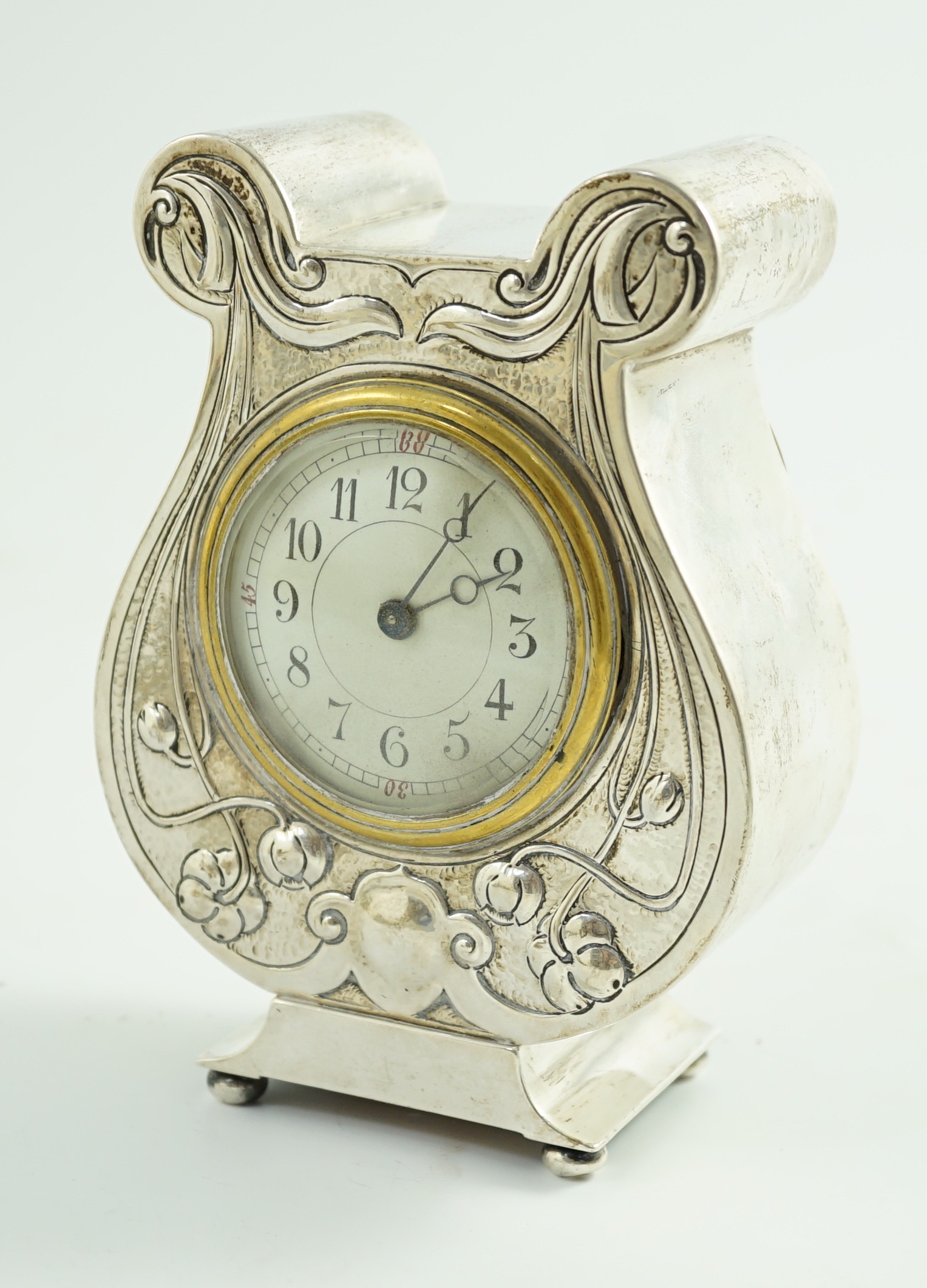 An Edwardian Art Nouveau silver cased mantel timepiece